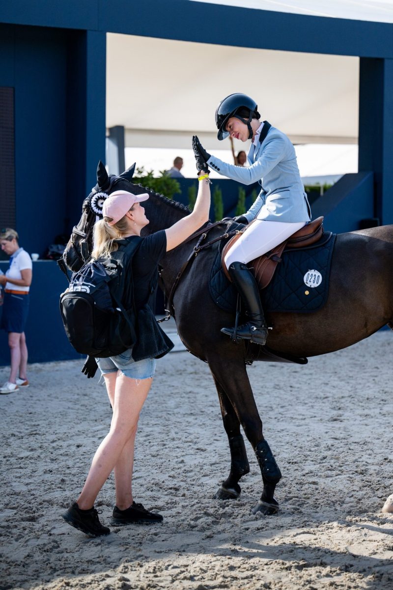 High-five with rider at a competition